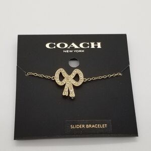 NWT Coach pave bow slider bracelet gold and clear
